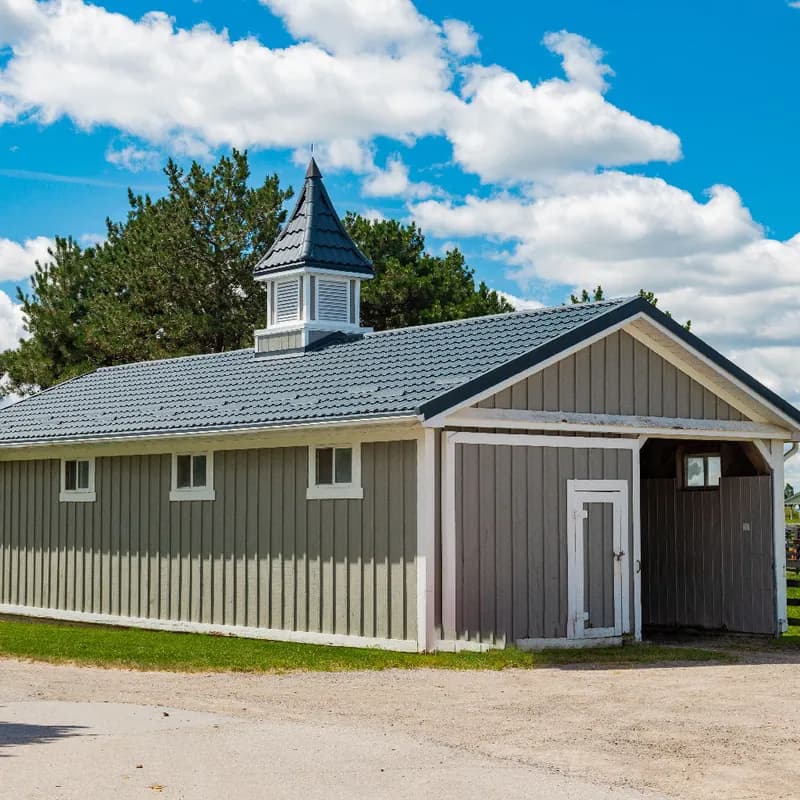 Agricultural building with a metal roof and cupola